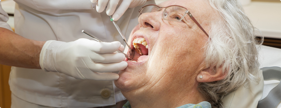 Dental hygienist caring for a long-term care resident